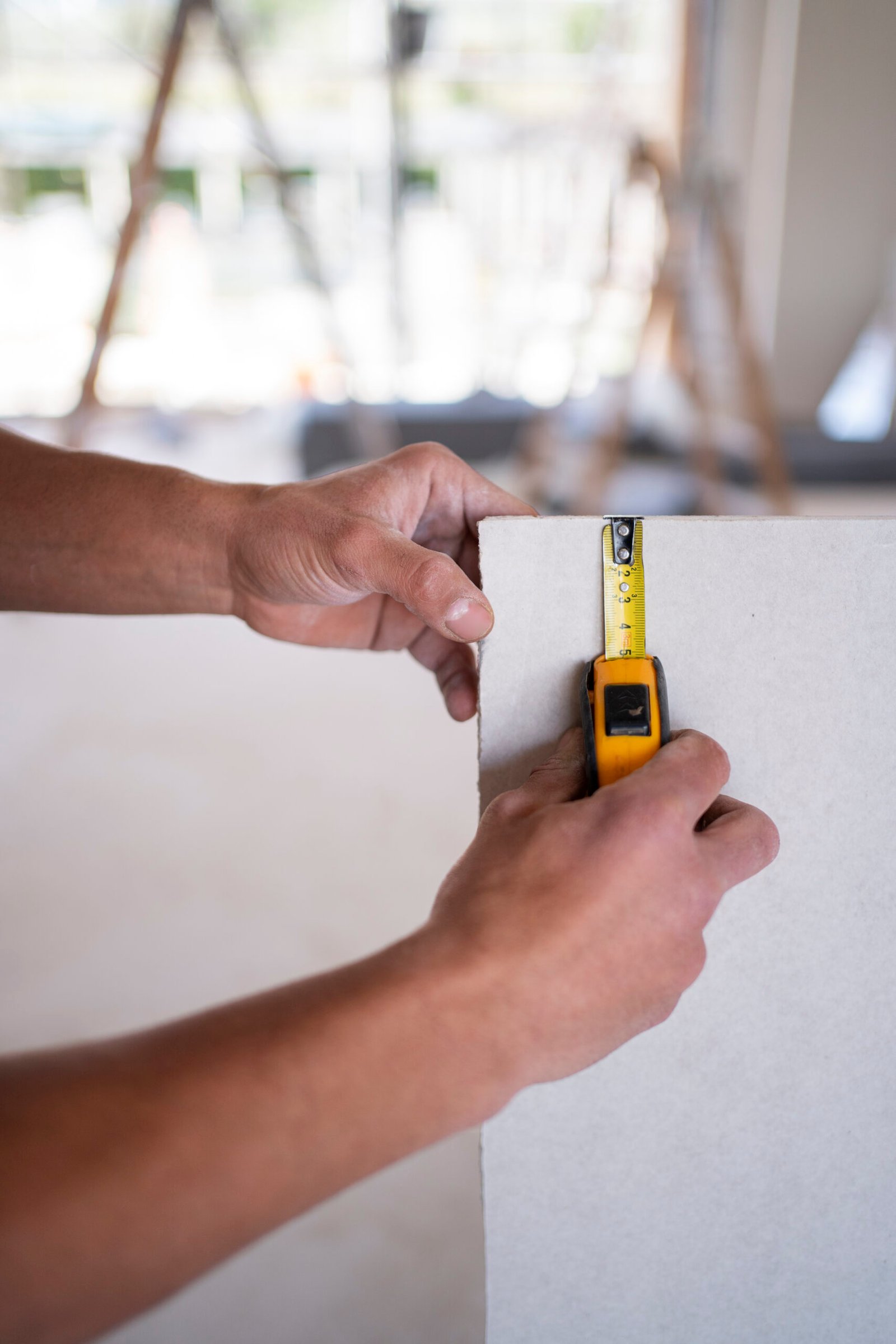 hands-using-tape-measuring-tool